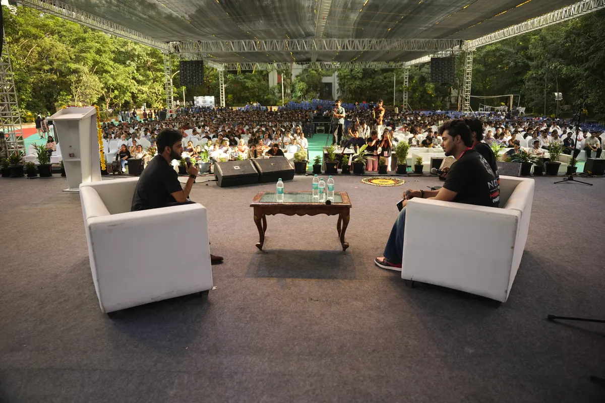 The conversation on stage, seen from behind the chairs, with the whole crowd in front